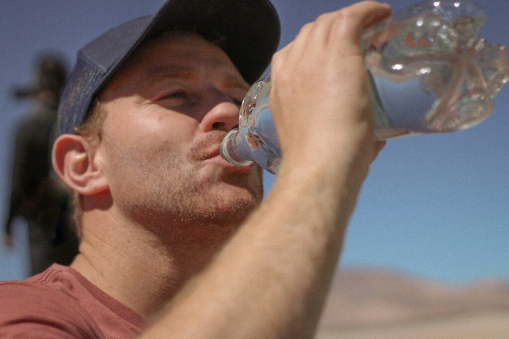 man drinking from water bottle 